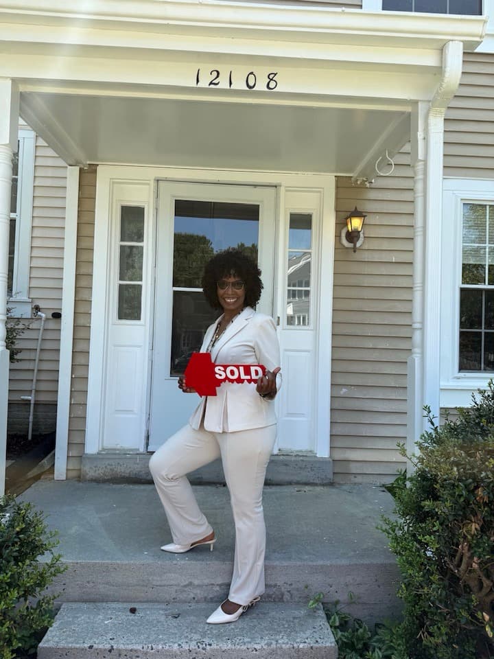 Manny Dado with SOLD sign at a closing